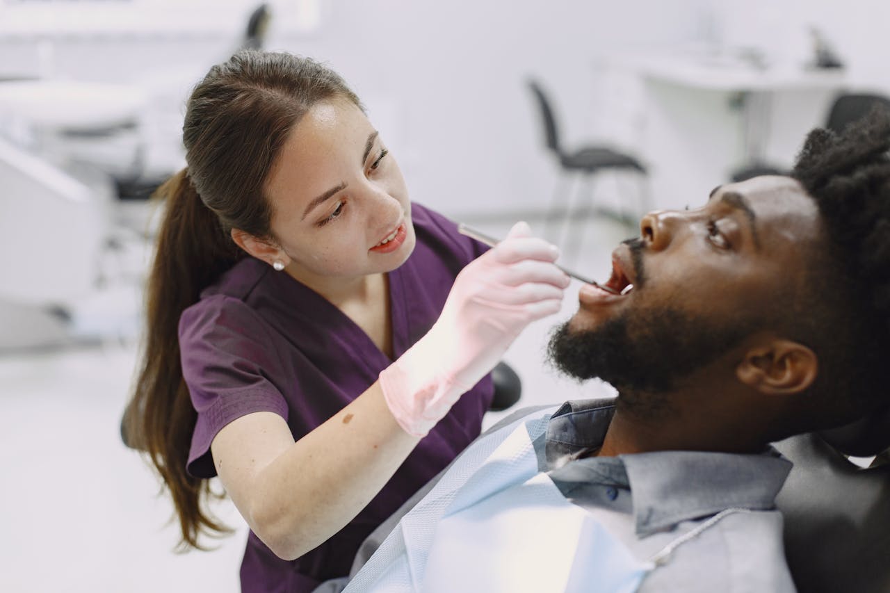 Dentist examining a patient during a dental check-up in a modern clinic. Professional care with focus on oral health.